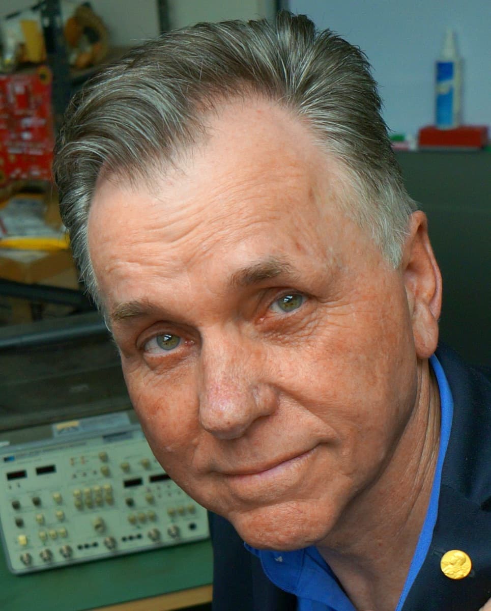 Barry Marshall, smiling, in a suit and open collar.