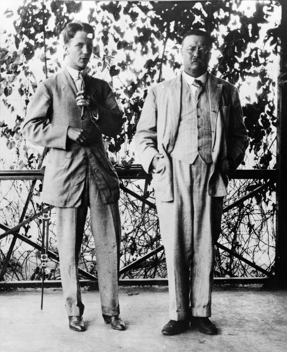 Theodore Roosevelt and his son Kermit standing together on a porch, 1910.