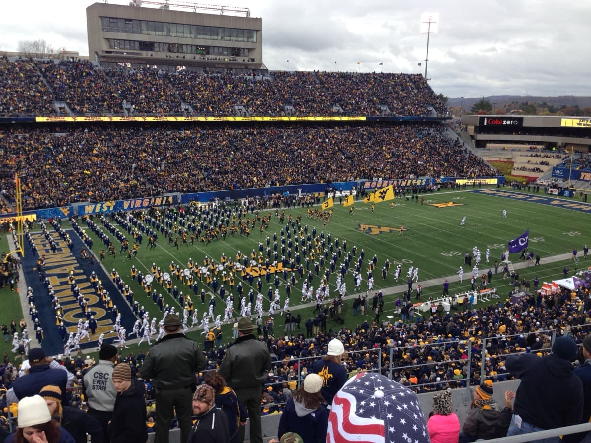 The West Virginia football team and the marching band entering Mountaineer Field before a game against TCU.